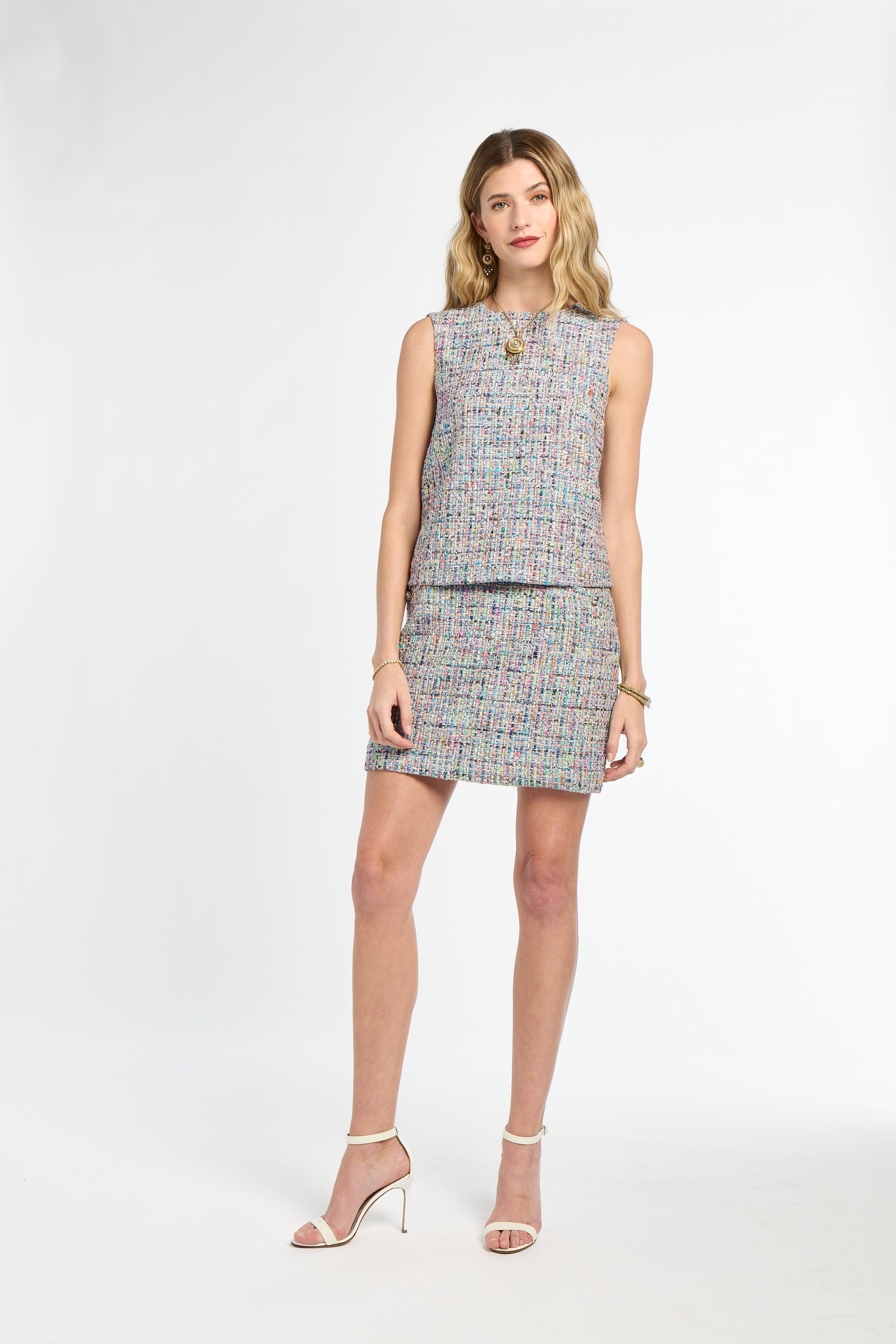 Woman wearing a patterned dress on a white background