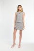 Woman wearing a patterned dress on a white background