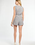 Woman wearing a patterned romper on a white background