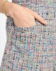 Multicolored textured fabric with a hand touching it
