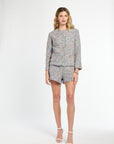 Woman wearing a patterned outfit on a white background