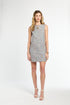 Woman wearing a patterned dress on a white background