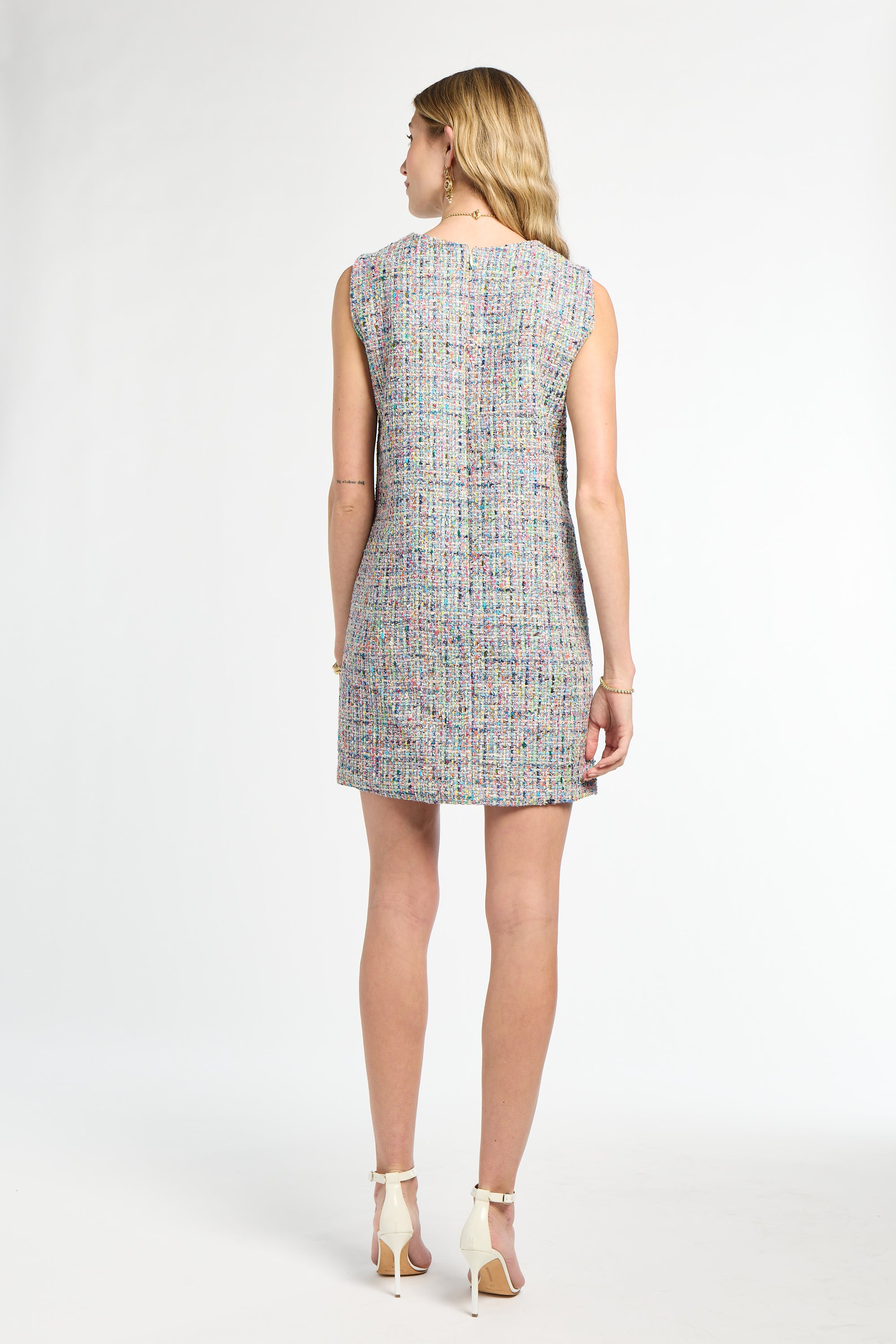 Woman wearing a patterned dress on a white background