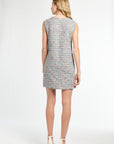 Woman wearing a patterned dress on a white background