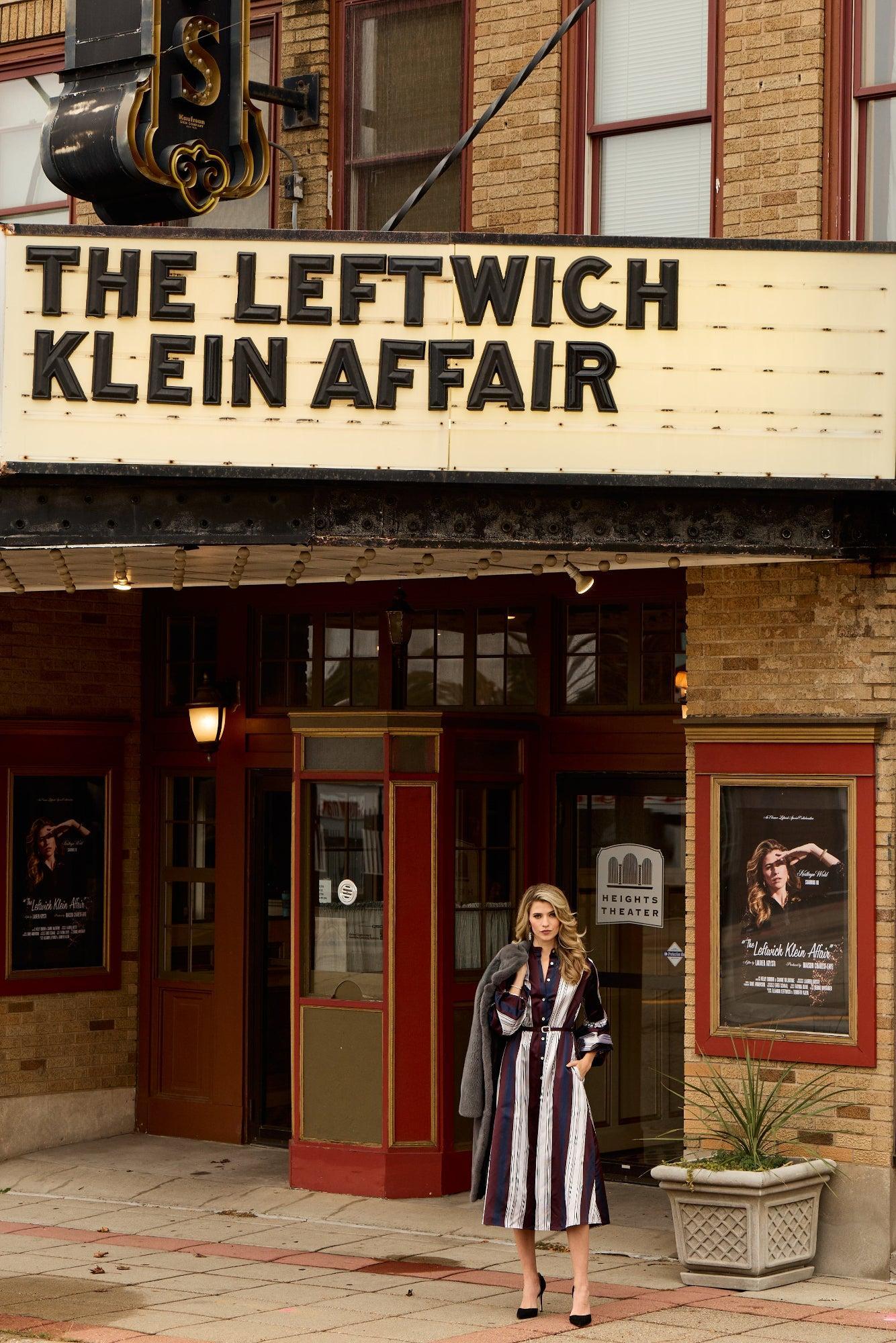 Woman standing in front of a theater with 'The Leftwich Klein Affair' marquee