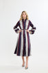 Woman wearing a striped dress on a white background