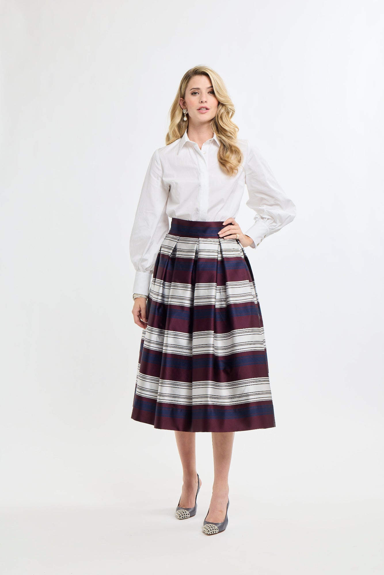 Woman wearing a white shirt and plaid skirt on a white background