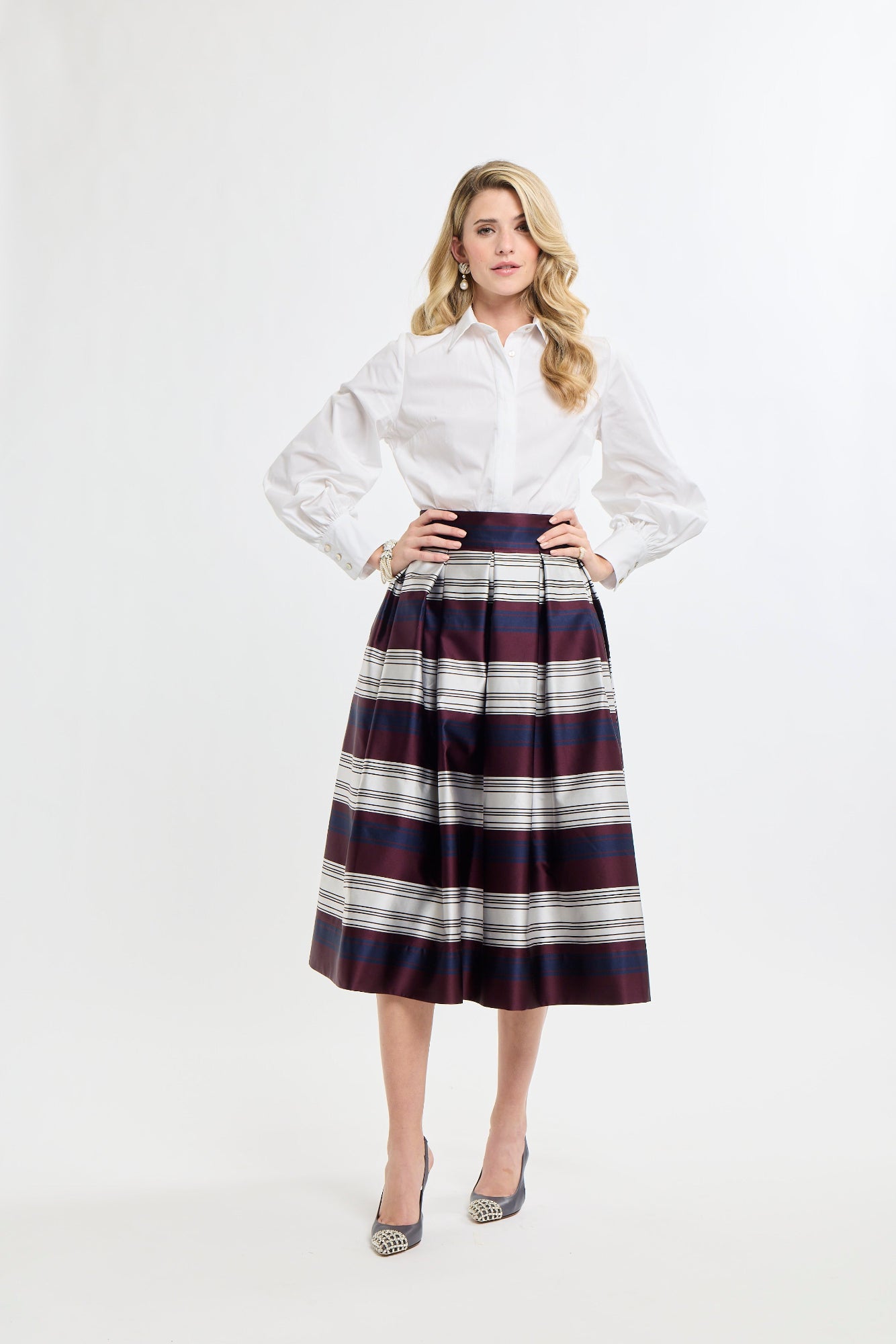 Woman wearing a white shirt and plaid skirt on a white background