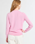 Woman wearing a pink sweater on a white background
