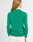 Person wearing a green sweater on a white background