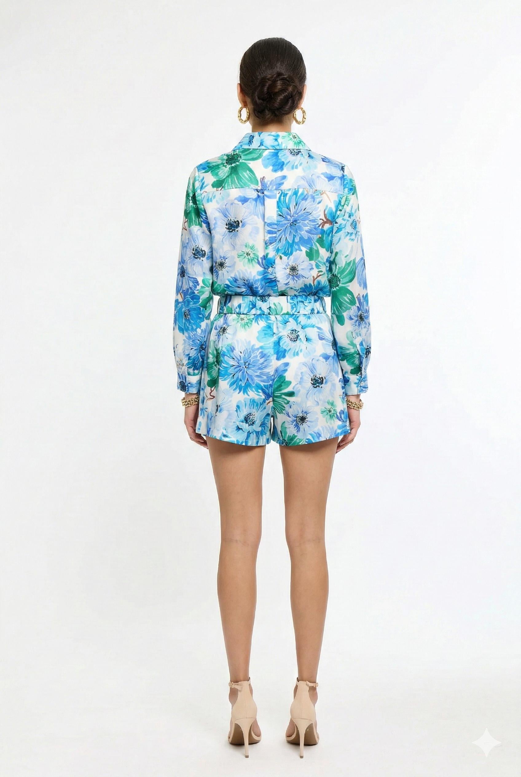 back of woman wearing matching green and blue floral shirt and short set