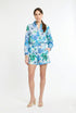 woman wearing matching green and blue floral shirt and short set