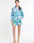 woman wearing matching green and blue floral shirt and short set