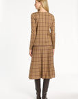 A woman modeling the chestnut reverse of the Cranberry Windowpane Plaid Crewneck with the matching skirt, back view, photographed against a plain white studio background.