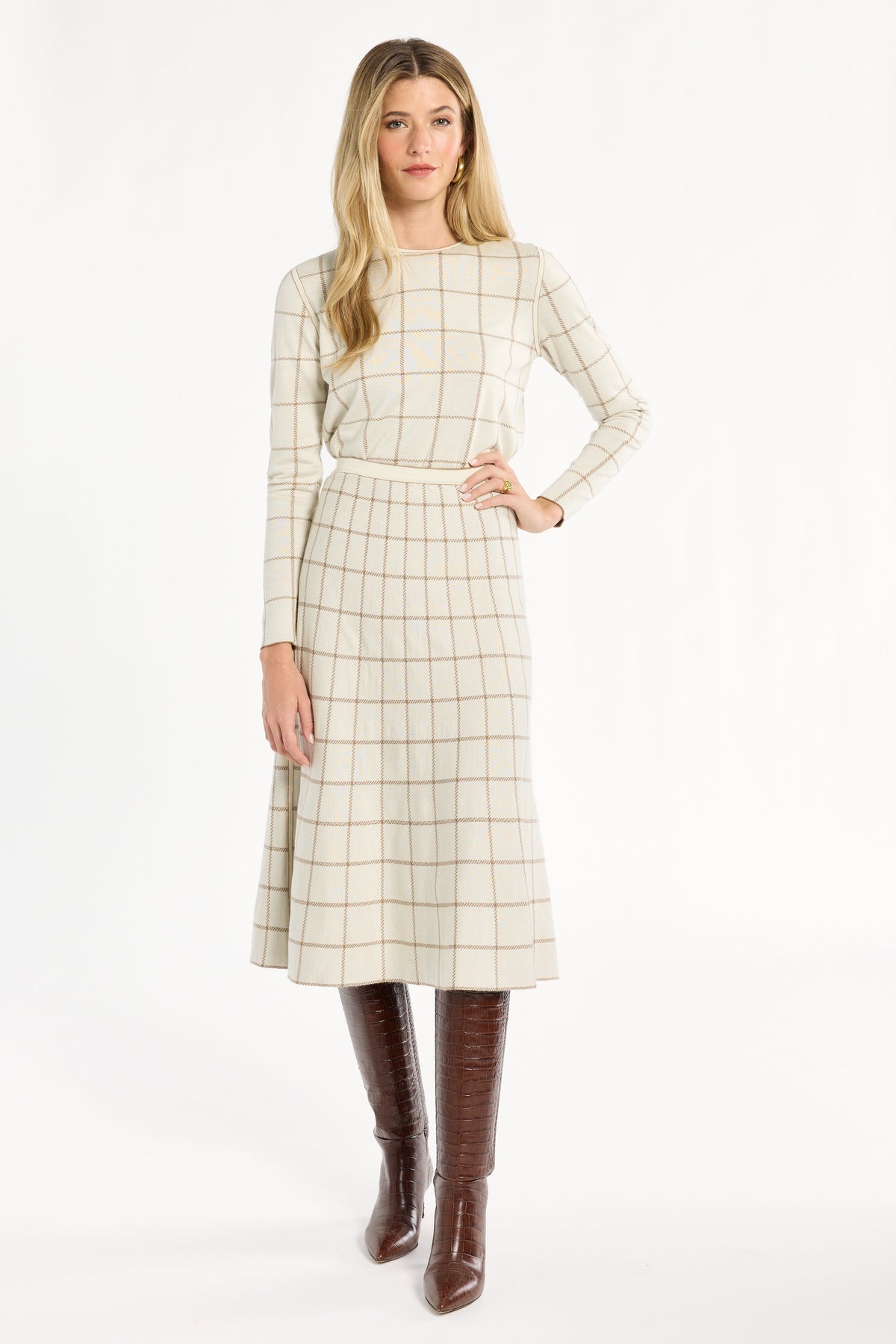 A woman modeling the cream side of the Chestnut Windowpane Plaid Reversible Flared Skirt with the matching crewneck, front view, photographed against a plain white studio background.