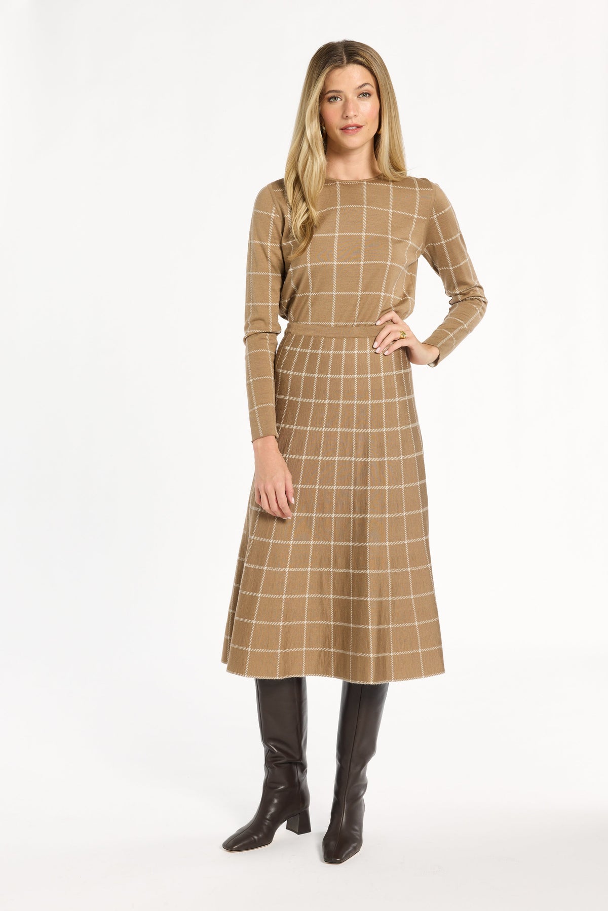A woman modeling the chestnut side of the Windowpane Plaid Reversible Flared Skirt with the matching crewneck, front view, photographed against a plain white studio background.