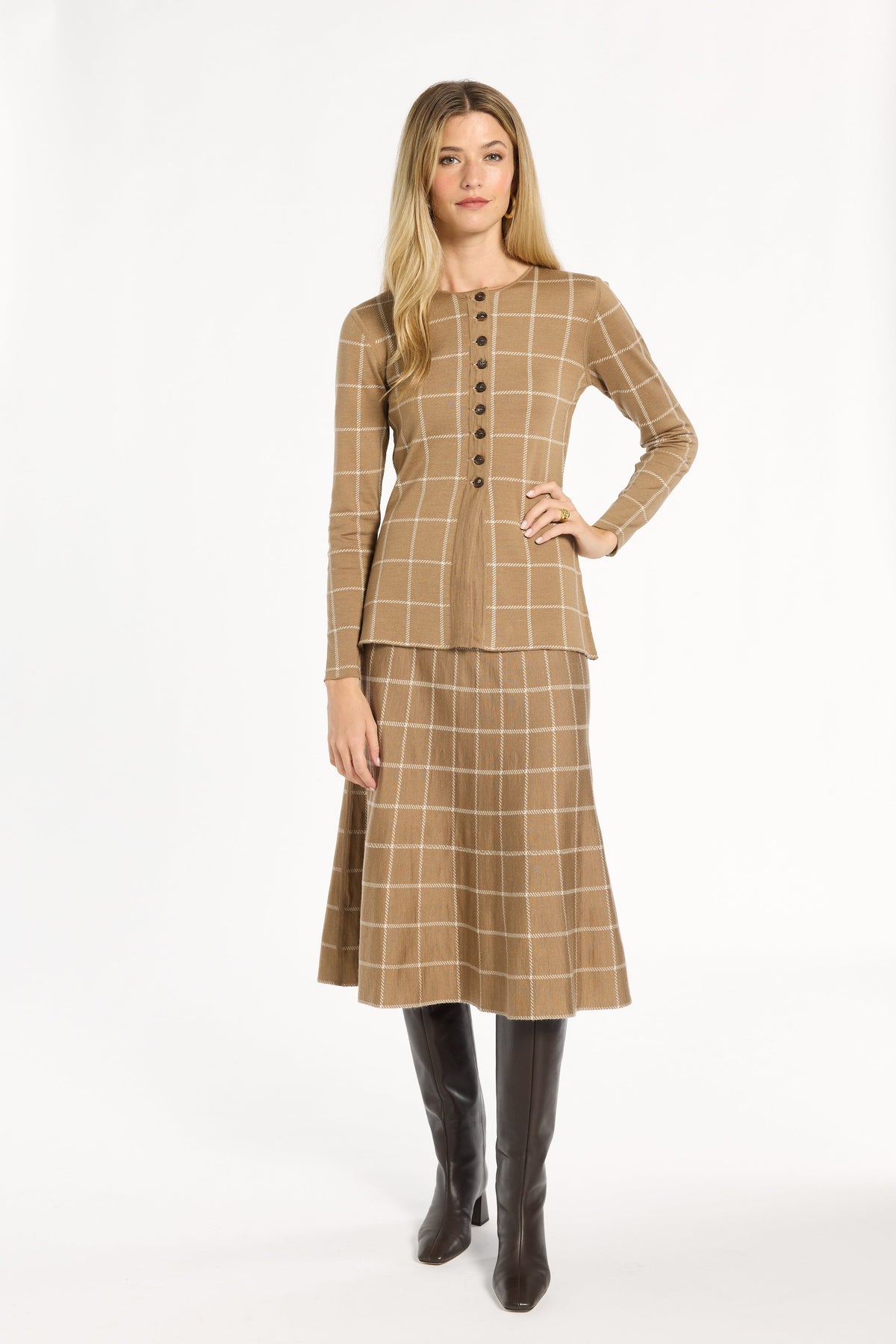 A woman modeling the chestnut side of the Windowpane Plaid Reversible Knit Jacket with the matching skirt, front view, photographed against a plain white studio background.