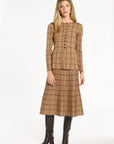 A woman modeling the chestnut reverse of the Cranberry Windowpane Plaid Knit Jacket with the matching skirt, front view, photographed against a plain white studio background.