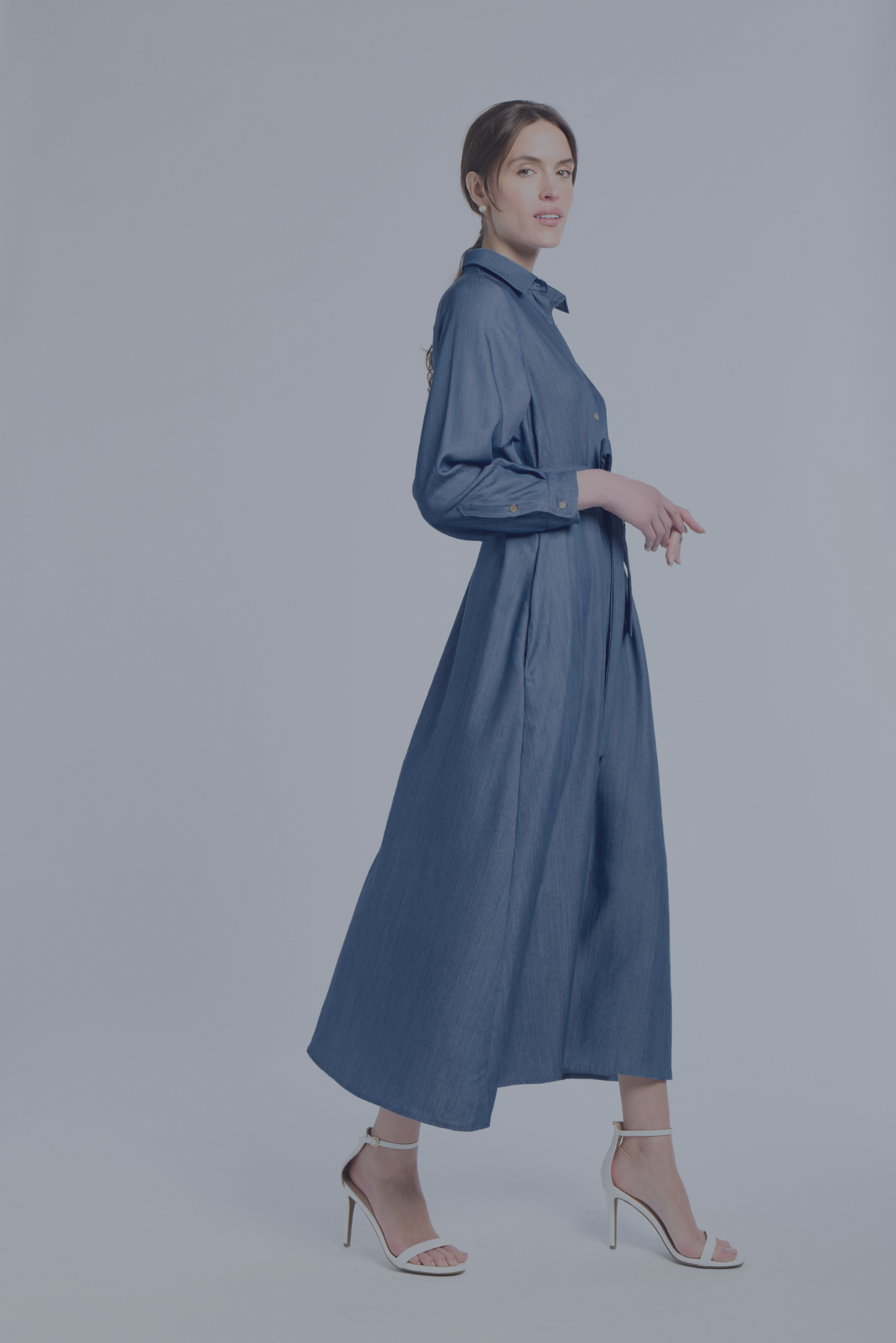 Woman wearing a blue dress on a white background