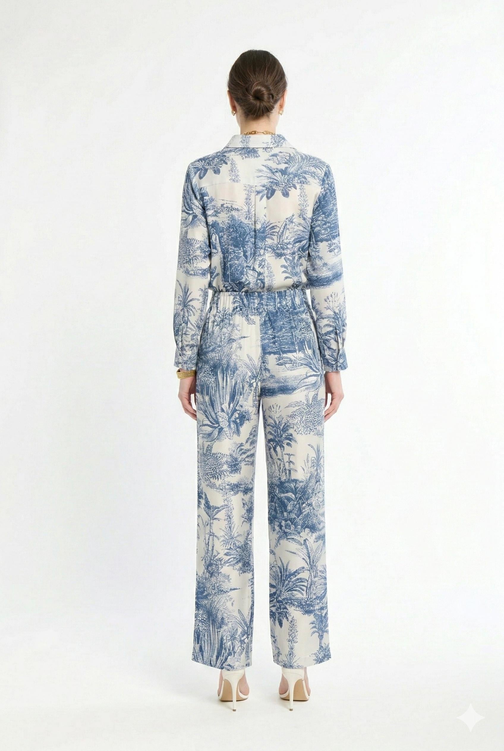 Back of woman wearing white and navy matching set on a white background