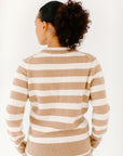 Back view of model wearing the Classic Striped Cashmere Crew in camel/cream stripes, paired with matching camel trousers.