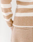 Close-up detail of the camel/cream Classic Striped Cashmere Crew, paired with camel trousers, highlighting the soft texture and fit.
