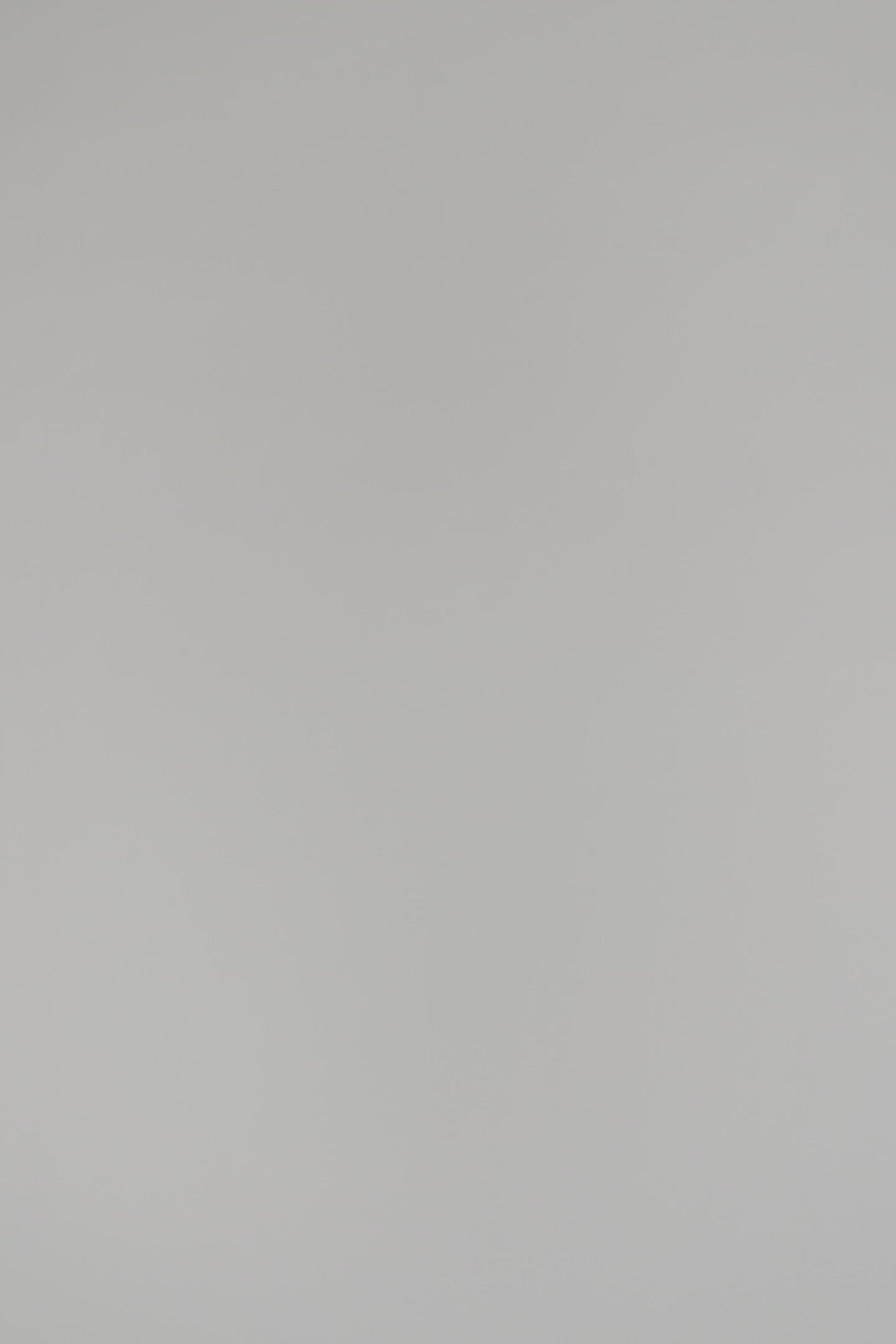 woman modeling cream v-neck sweater on a white backdrop