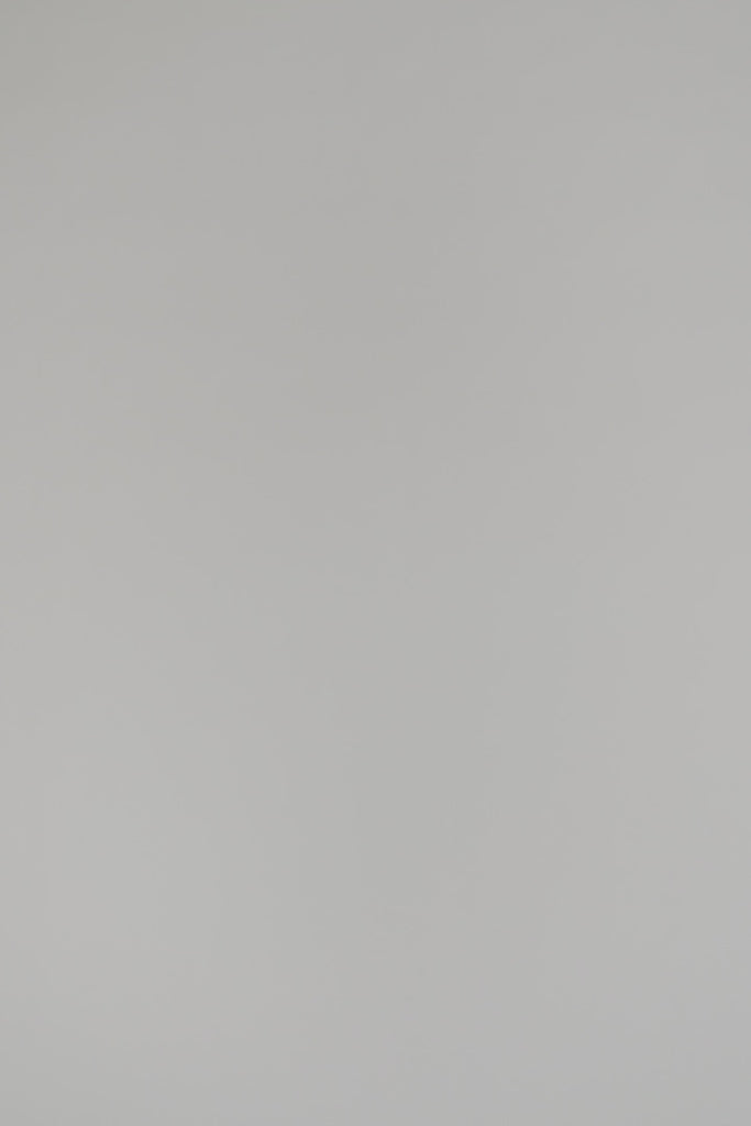 woman modeling cream v-neck sweater on a white backdrop