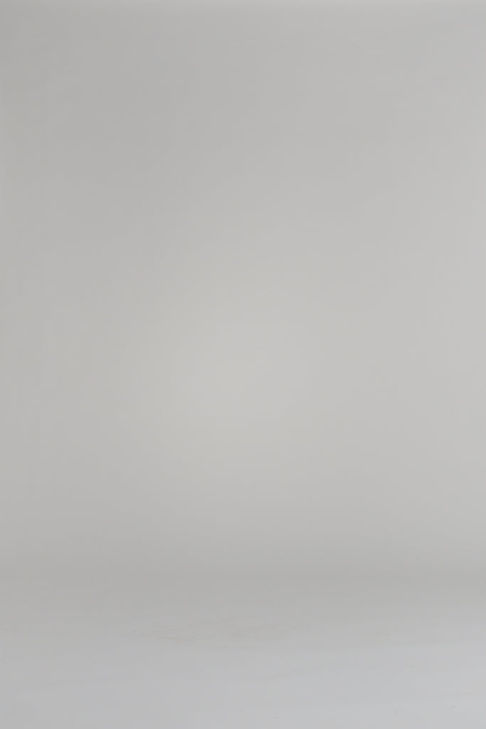 woman wearing a white floral dress on a white backdrop
