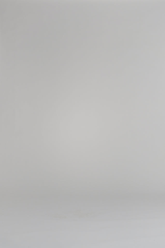 woman modeling an ivory cardigan on a white backdrop
