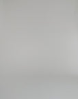 woman modeling floral long sleeve top against a white backdrop