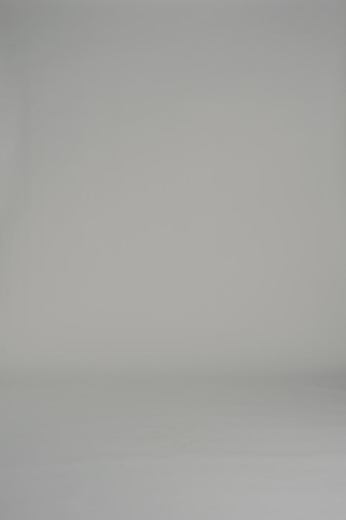 woman modeling a white blouse and pants set on a white backdrop