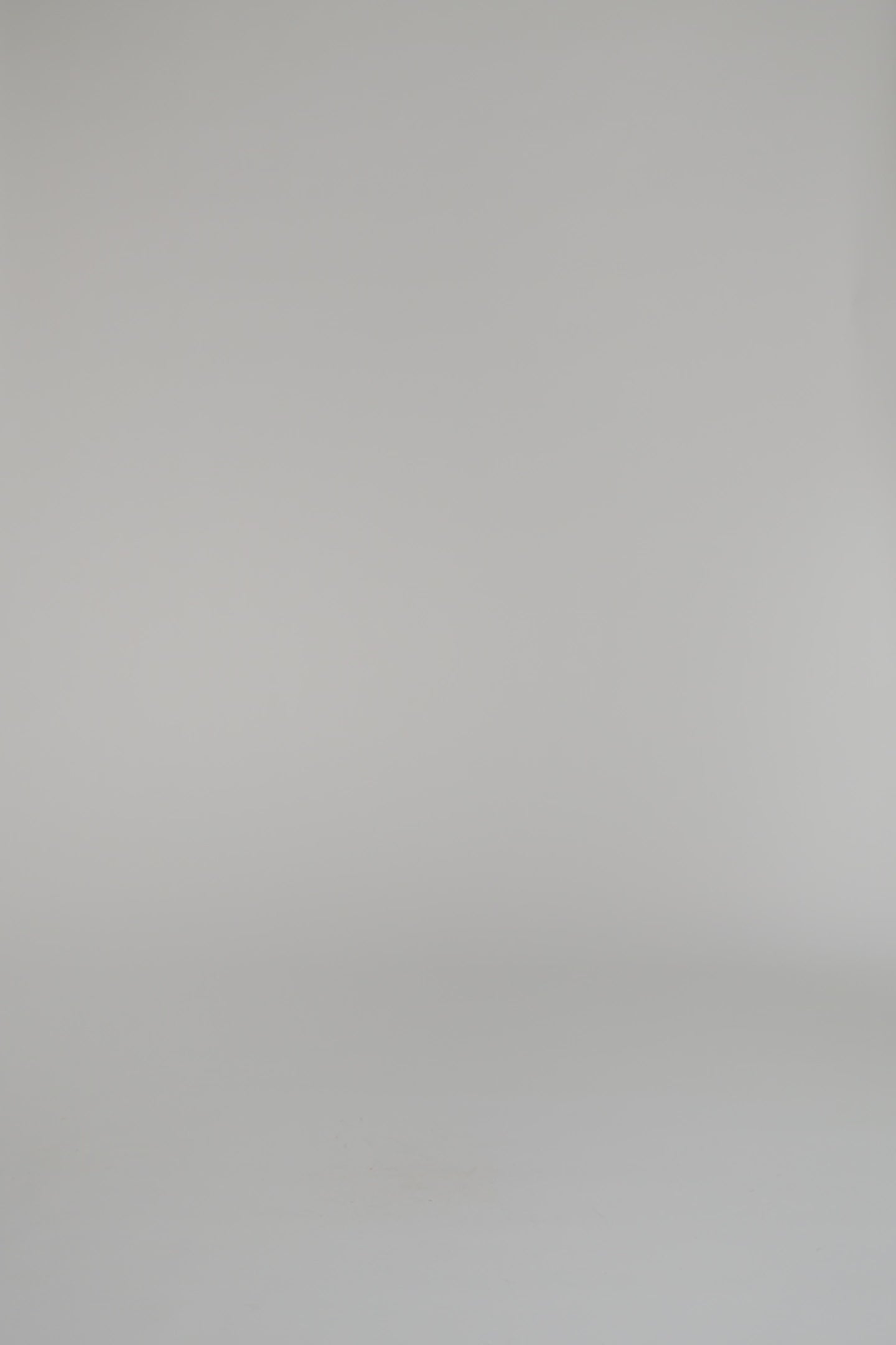 woman wearing a pink turtleneck and long skirt on a white backdrop