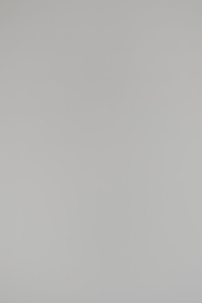 Woman wearing cream crewneck on a white background