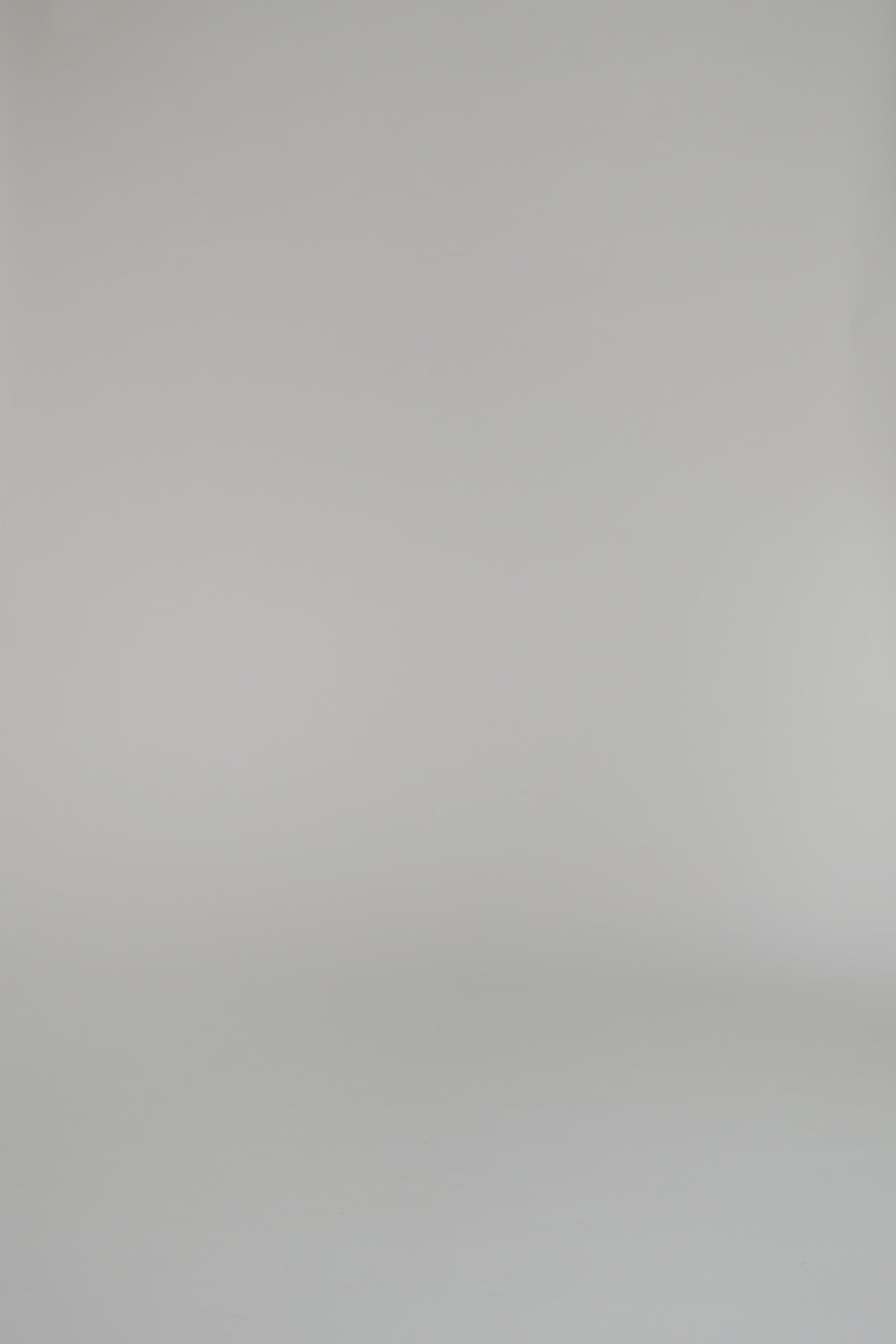 woman modeling a gold and white patterned shirt against a white background