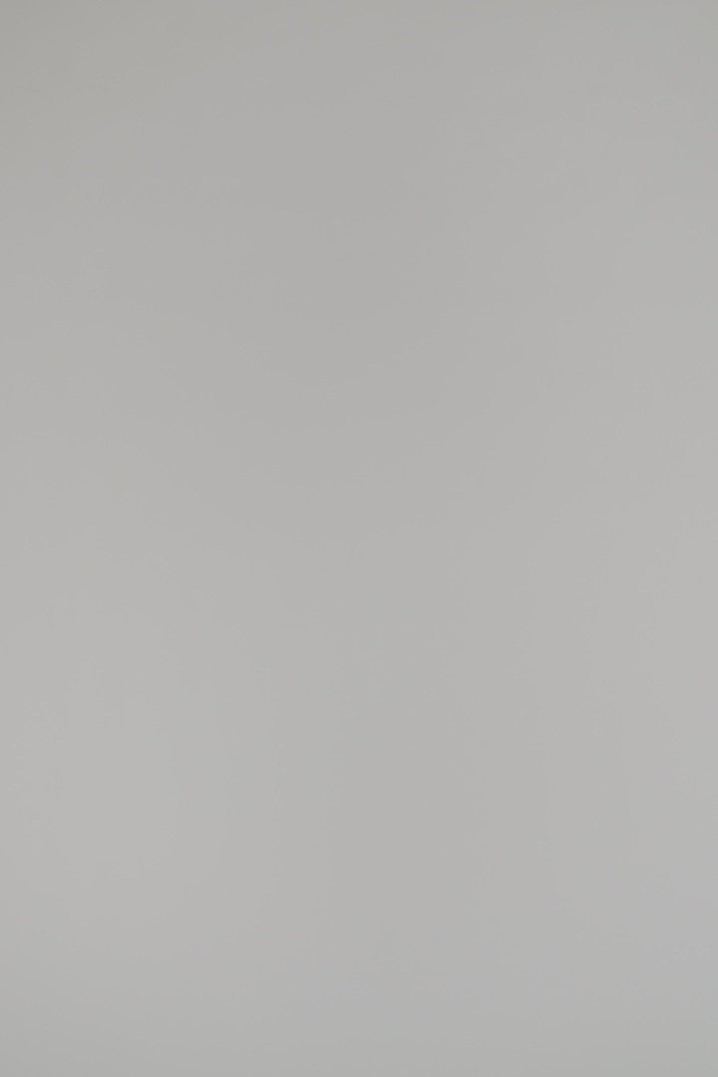 woman wearing a navy cashmere cardigan against a white backdrop