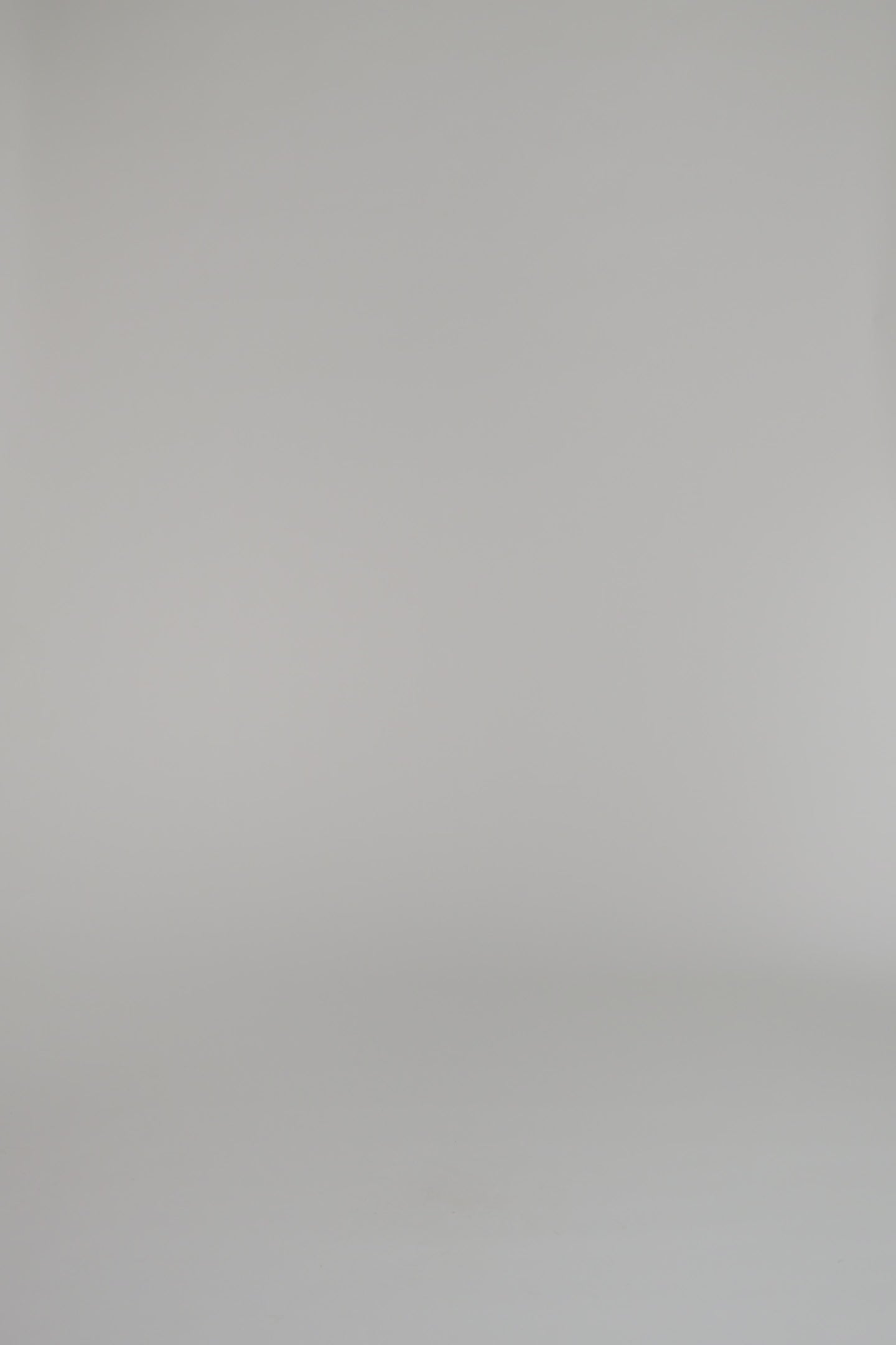 woman modeling long sleeve red dress with black heels against a white background