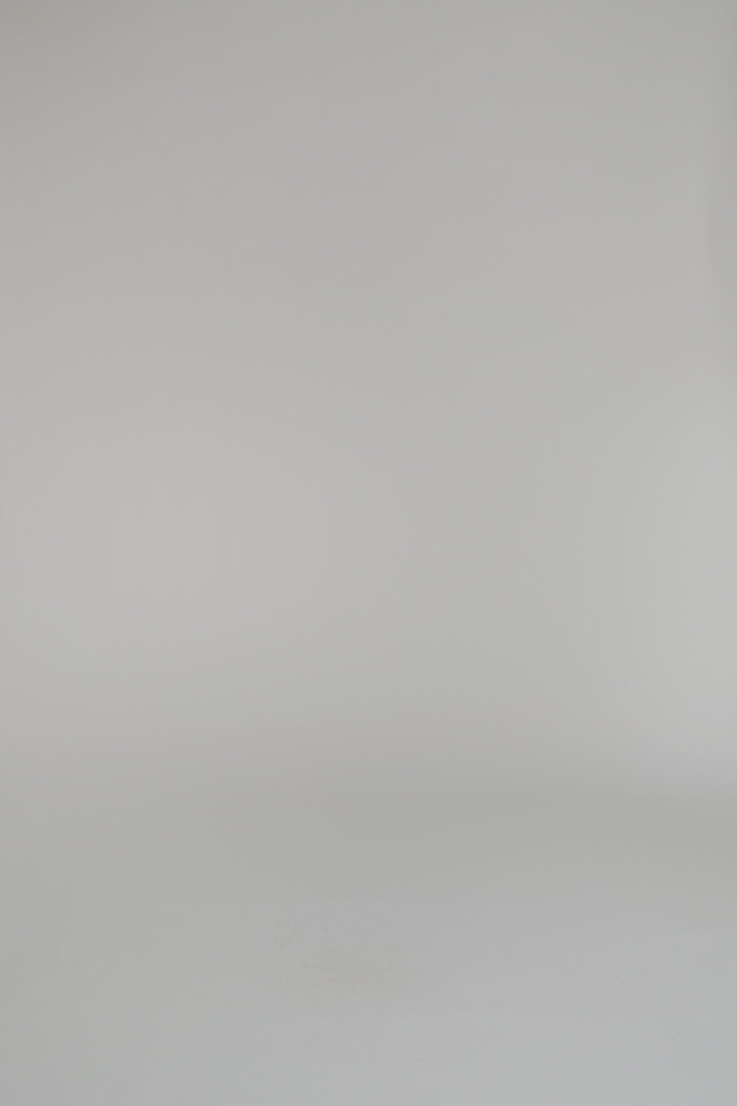 woman wearing an ivory sweater on a white backdrop