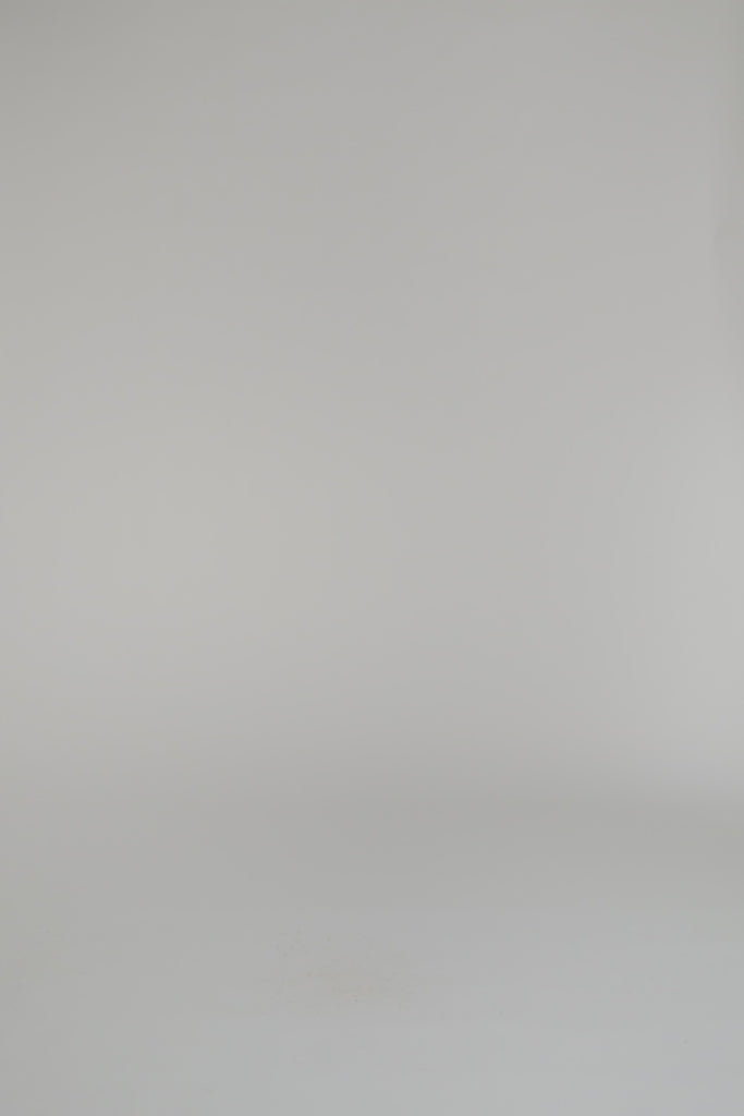 woman wearing an ivory sweater on a white backdrop
