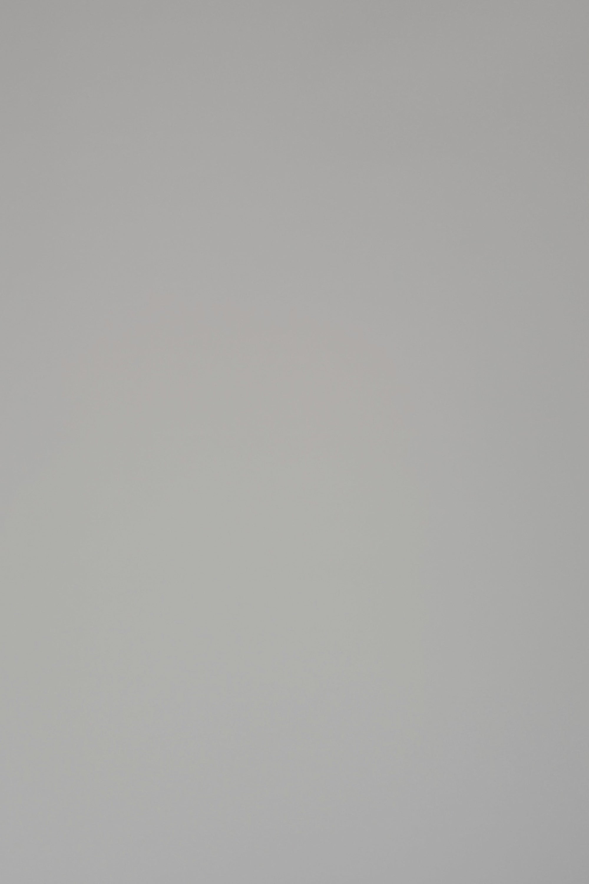 Woman modeling a navy cotton t-shirt on a white backdrop