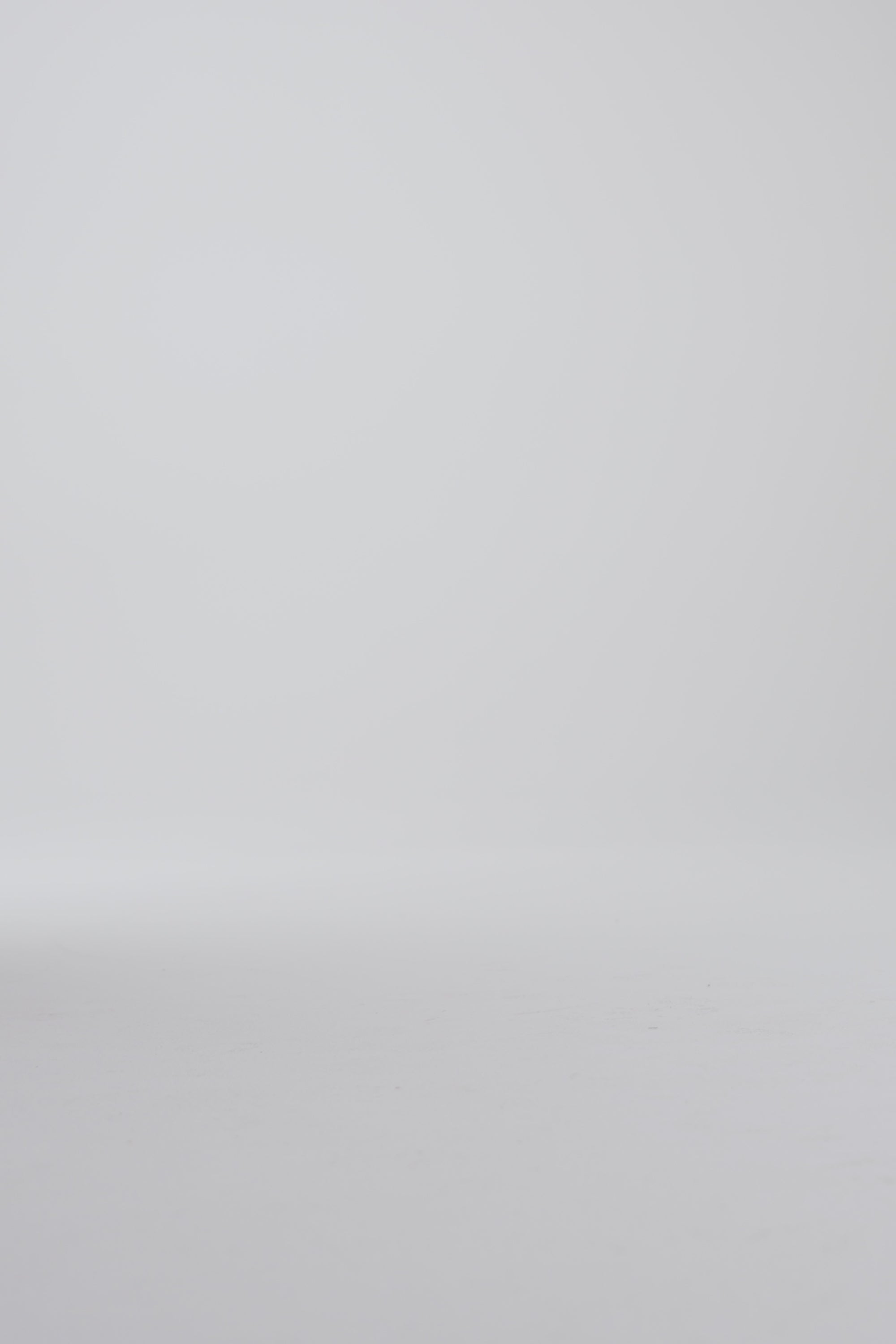 Model walking in dark brown derby shoes on a white backdrop