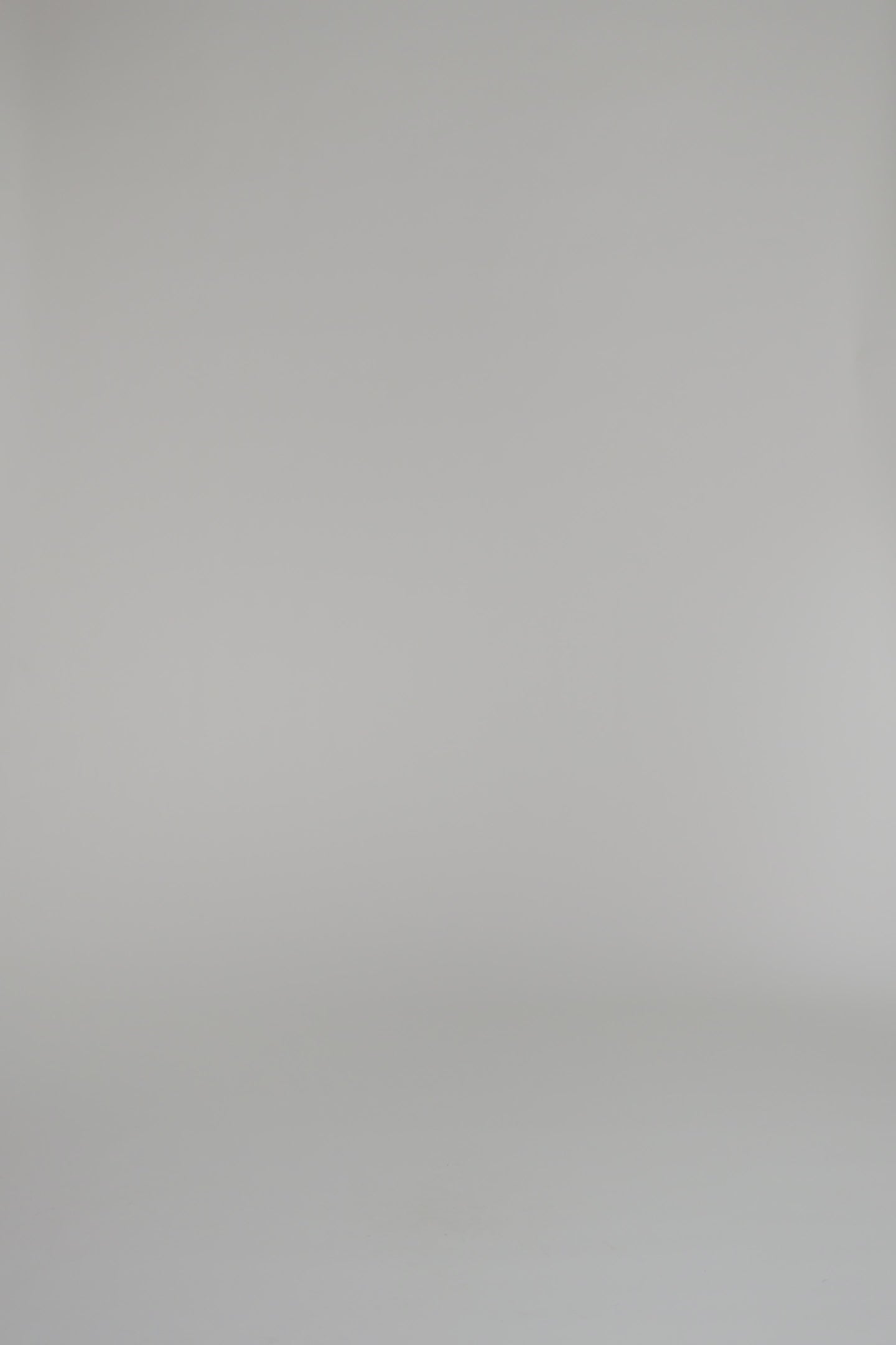 woman modeling a merlot cardigan and skit on a white background