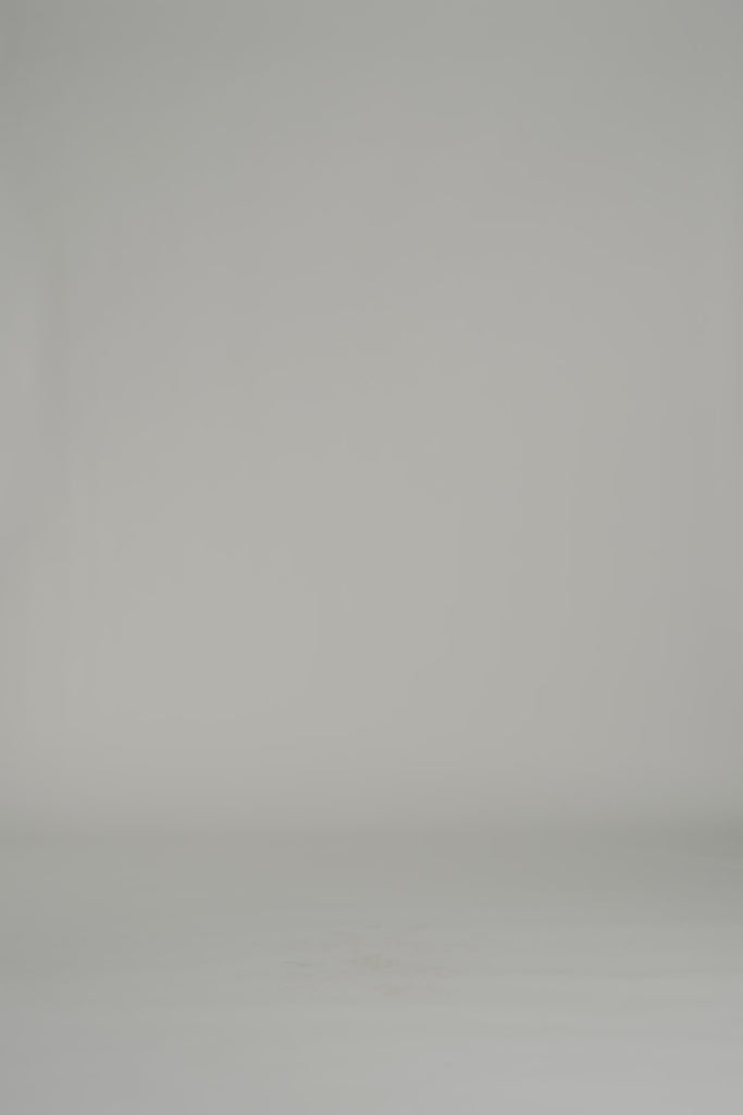 video of a woman in a daisy patterned mid length dress on a gray backdrop