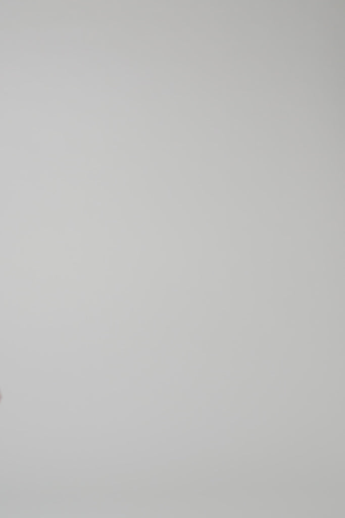 Dark red long sleeve cashmere turtleneck being modeled by a woman on a white backdrop