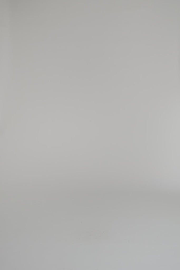 woman modeling merlot patterned wrap on a white backdrop