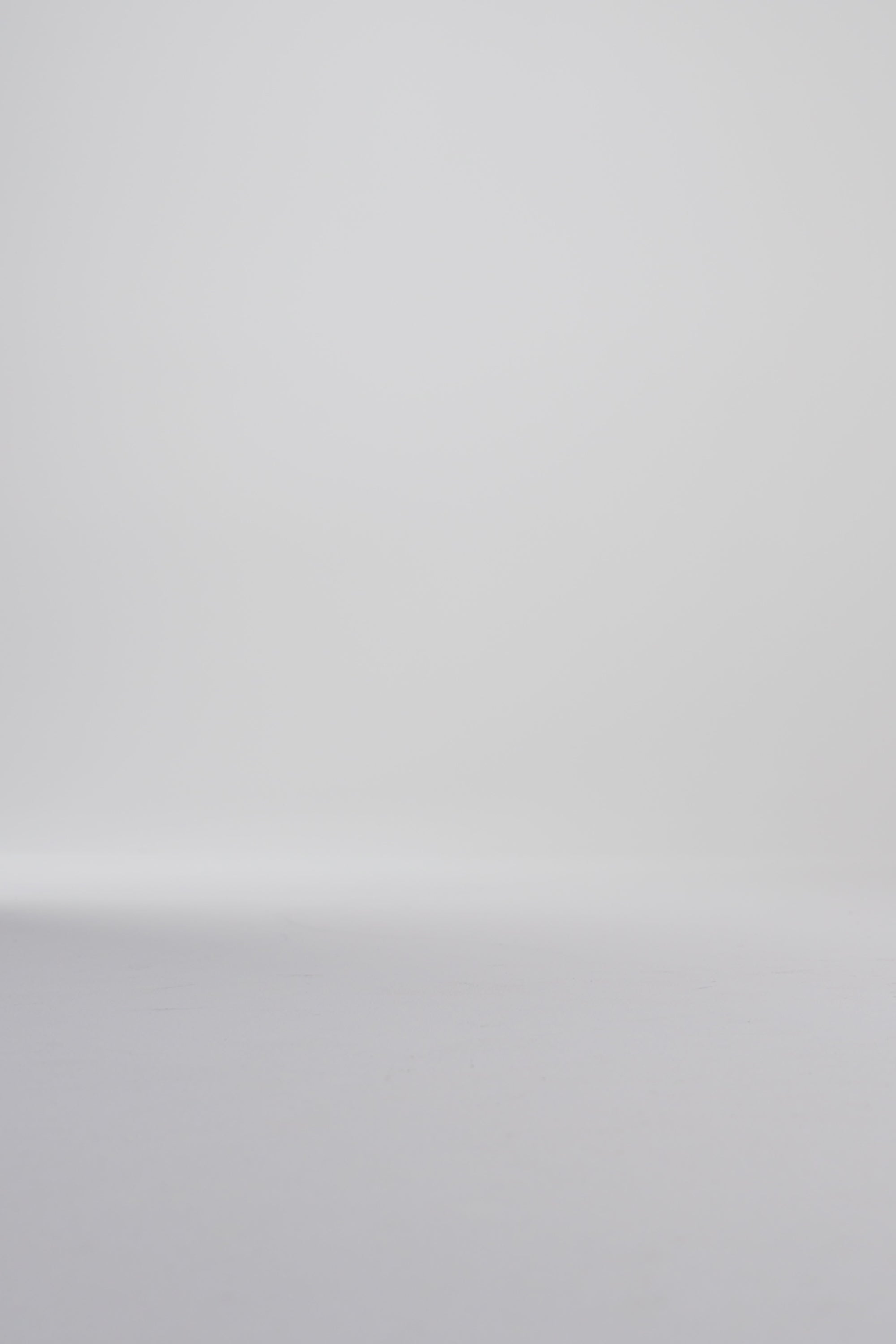 Woman modeling black oxford shoes on a white backdrop