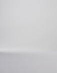 Woman modeling black oxford shoes on a white backdrop