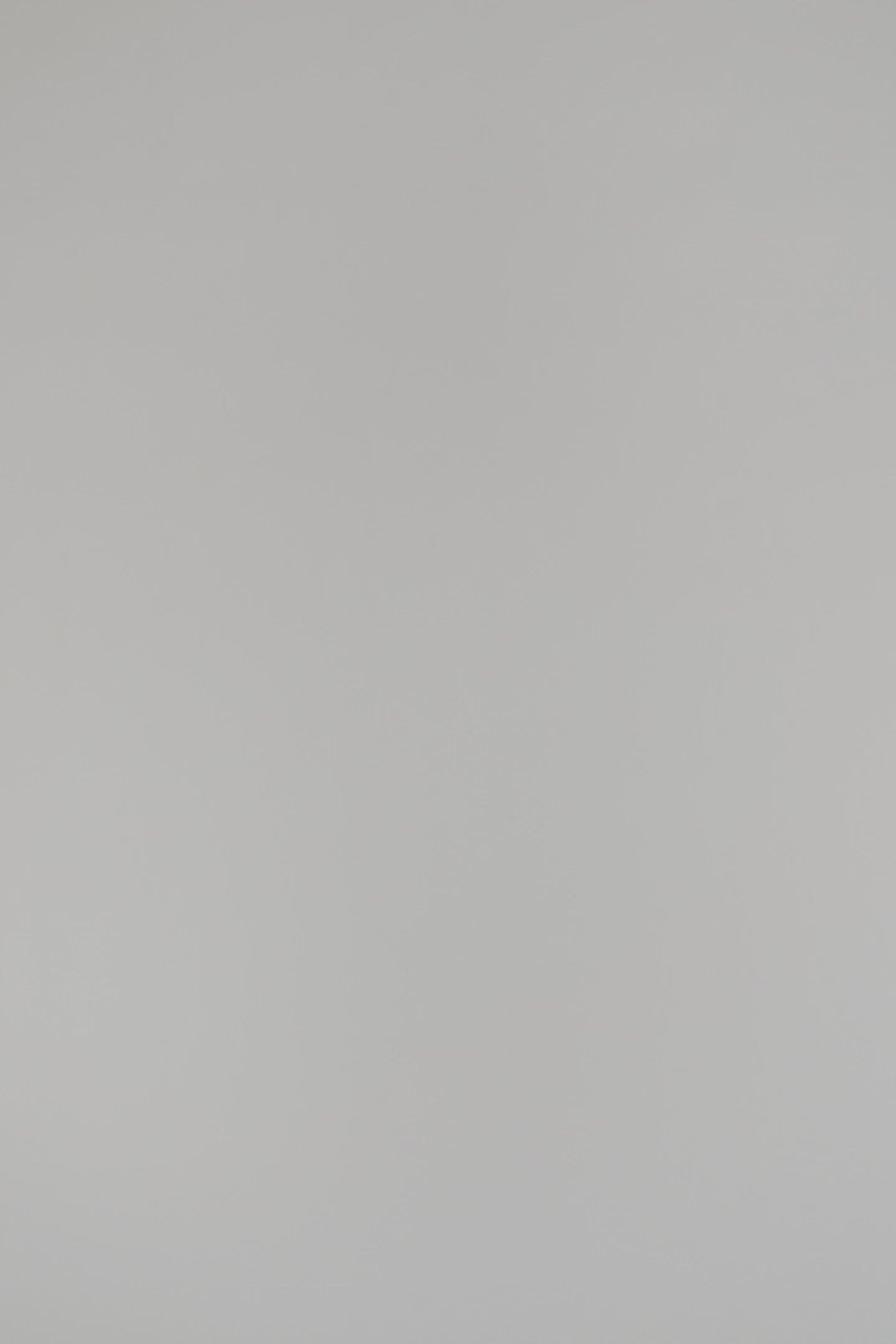 woman modeling a blue cashmere sweater with gold jewelry against a white background