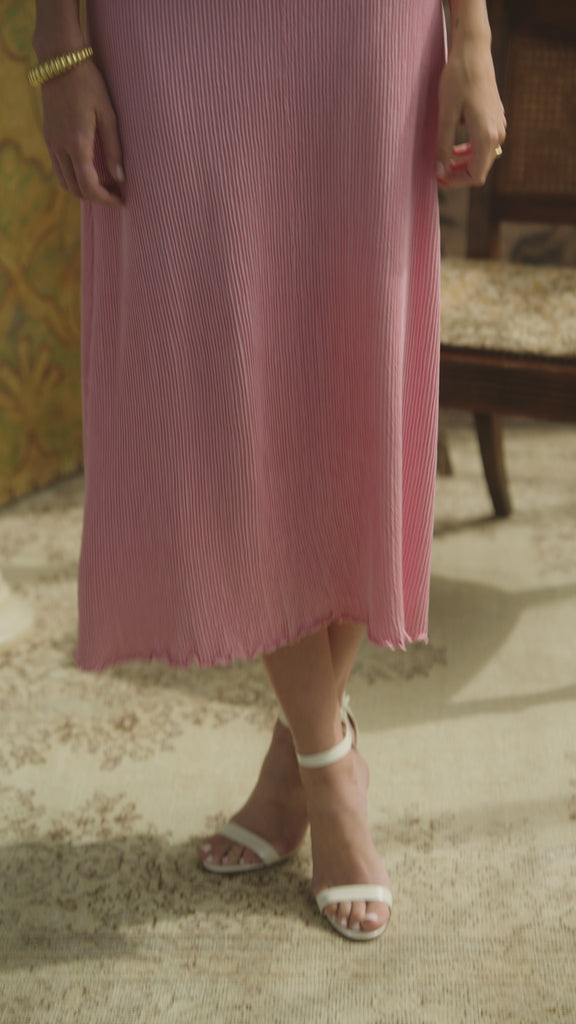 Woman modeling a silk skirt in peak that is pleated in a room