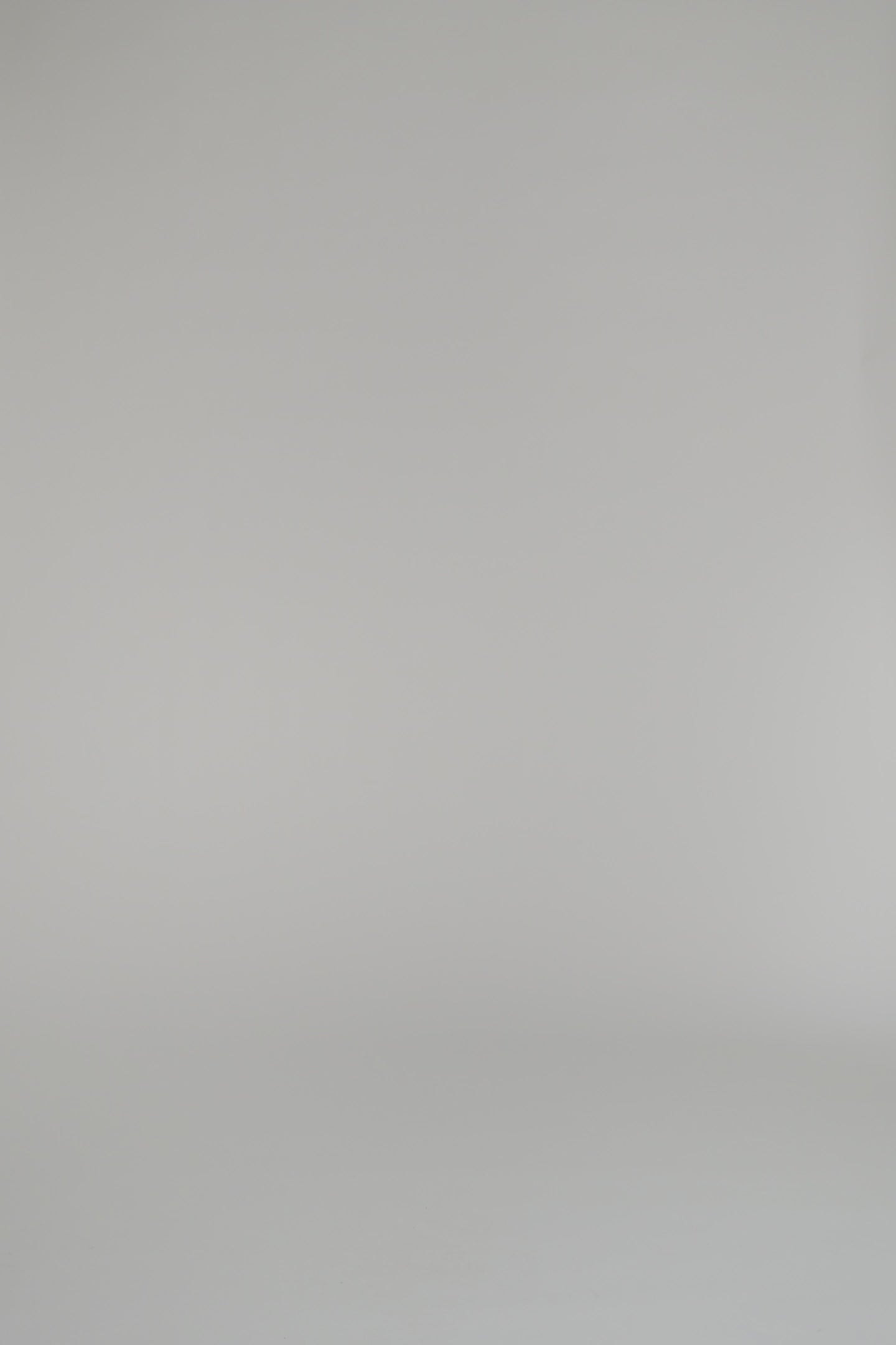 woman modeling cream blouse with gold shorts